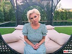 Charli Phoenix, a mature stepmother, performs a seductive striptease for her stepson outdoors, revealing her ample bosom and tantalizing figure.